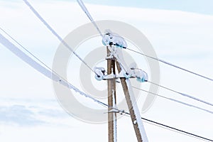 Electricity post after heavy blizzard, close up. Energy resource concept