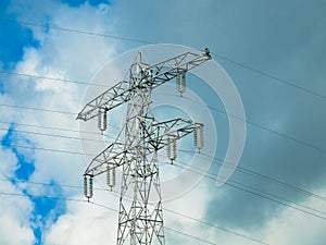 Electricity power line with pylon against dramatic sky, close-up.  Renewable energy concept