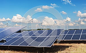 electricity power in nature. clean energy concept. solar panel with turbine and blue sky background