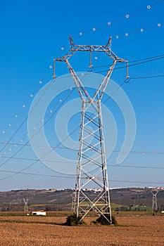 Electricity Power Pylons against Bright Blue Sky