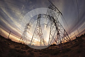 Electricity power pylons at sunset