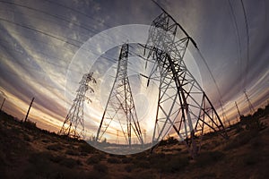 Electricity power pylons at sunset photo