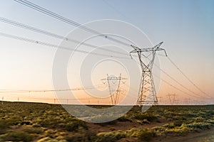 Electricity power tower line pylons at the sunrise.