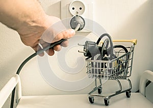 Electricity price increases, Concept, Shopping trolley with cable and electrical outlet