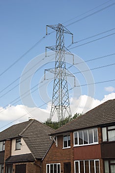 Electricity pylon adjacent to houses