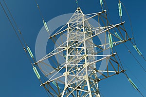 Electricity pylon against the blue sky.