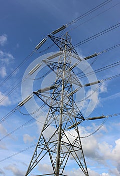 Electricity pylon against blue sky on a sunny day