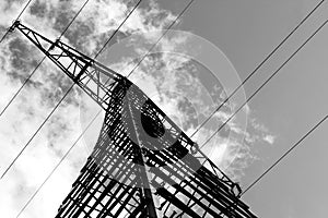 Electricity pylon with cloudy sky in black and white