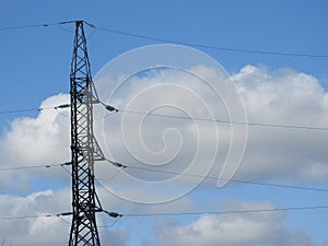 Electricity pylon, electric transmission tower, against the blue sky. Energy tower