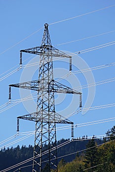 Electricity pylon, high-voltage power against blue sky