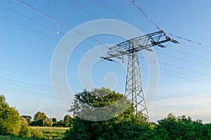 Electricity pylon and high voltage power line in field