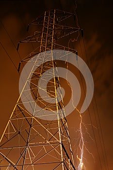 Electricity Pylon with Lightning in Background.