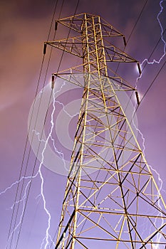 Electricity Pylon with Lightning in Background.