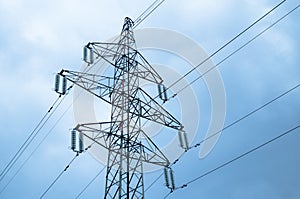 Electricity pylon with power lines against blue sky