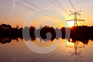 Electricity pylon with reflection in water