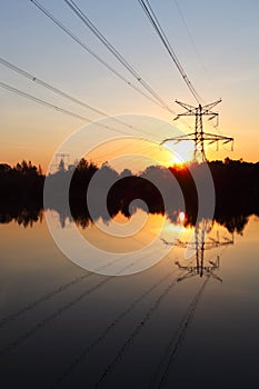 Electricity pylon with reflection in water