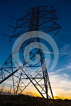 Electricity pylon seen from below at sunset