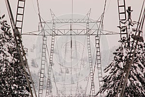 Electricity pylon shrouded in winter