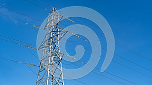 Electricity pylon in the UK shot  against a blue sky