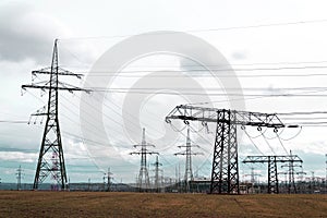 Electricity pylons conducting current from distribution power station, solar renewable energy and grid stability concept