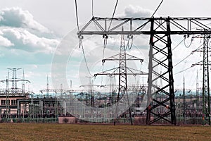 Electricity pylons conducting current from distribution power station, solar renewable energy and grid stability concept