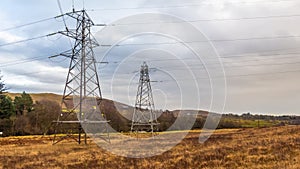 Electricity pylons in a field on a cloudy day in winter at Kendoon Power Station