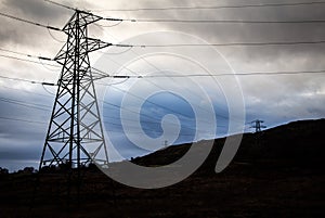 Electricity pylons in a field on a cloudy day in winter at Kendoon Power Station