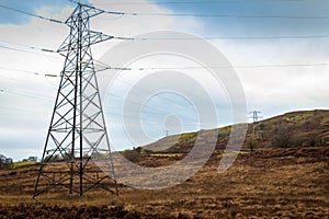 Electricity pylons in a field on a cloudy day in winter at Kendoon Power Station