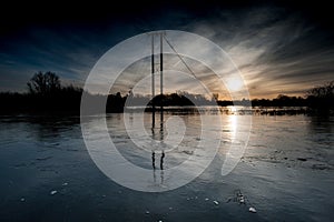 Electricity pylons in flooded field