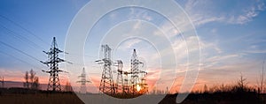 Electricity pylons and lines at dusk