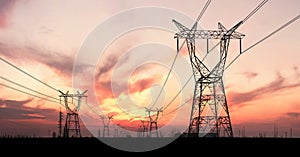 Electricity pylons and lines at dusk