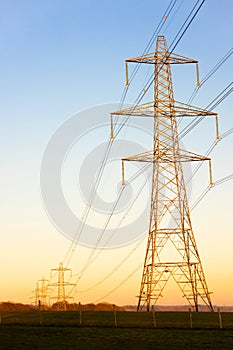 Electricity Pylons of the National Grid at Sunset or Sunrise