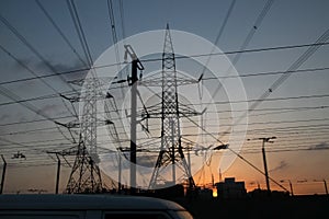 Electricity pylons and power lines, at sunset