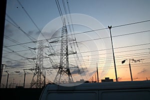 Electricity pylons and power lines, at sunset