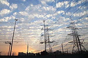 Electricity pylons and power lines, at sunset