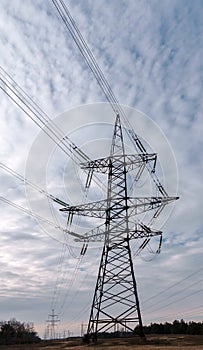 Electricity pylons and power lines, at sunset.