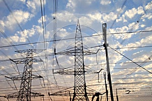 Electricity pylons and power lines, at sunset