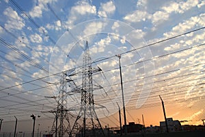 Electricity pylons and power lines, at sunset