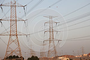 Electricity pylons and power lines, at sunset