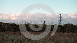 Electricity Pylons in Serene Landscape photo