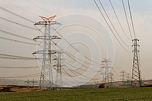 Electricity pylons at sunset, power transmission lines