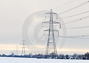 Electricity pylons in a winter landscape with snow. UK