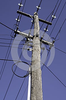Electricity rural wooden utility pole with cables, lines and insulators in Melbourne