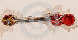 Electricity socket installation on white wall