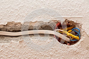 Electricity socket installation on white wall