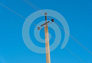 An electricity supply pylon a blue sky background. Concept of power line. Energy or power image