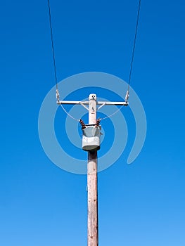 An electricity supply pylon delivering power through the UK national grid showing power cables, isolators and other equipment.