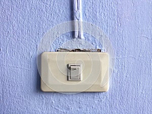 Electricity switch on blue wall background