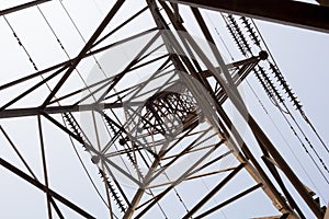 Electricity tower overhead power line transmission tower on background blue sky.