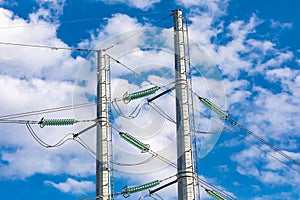 Electricity towers against a blue sky.